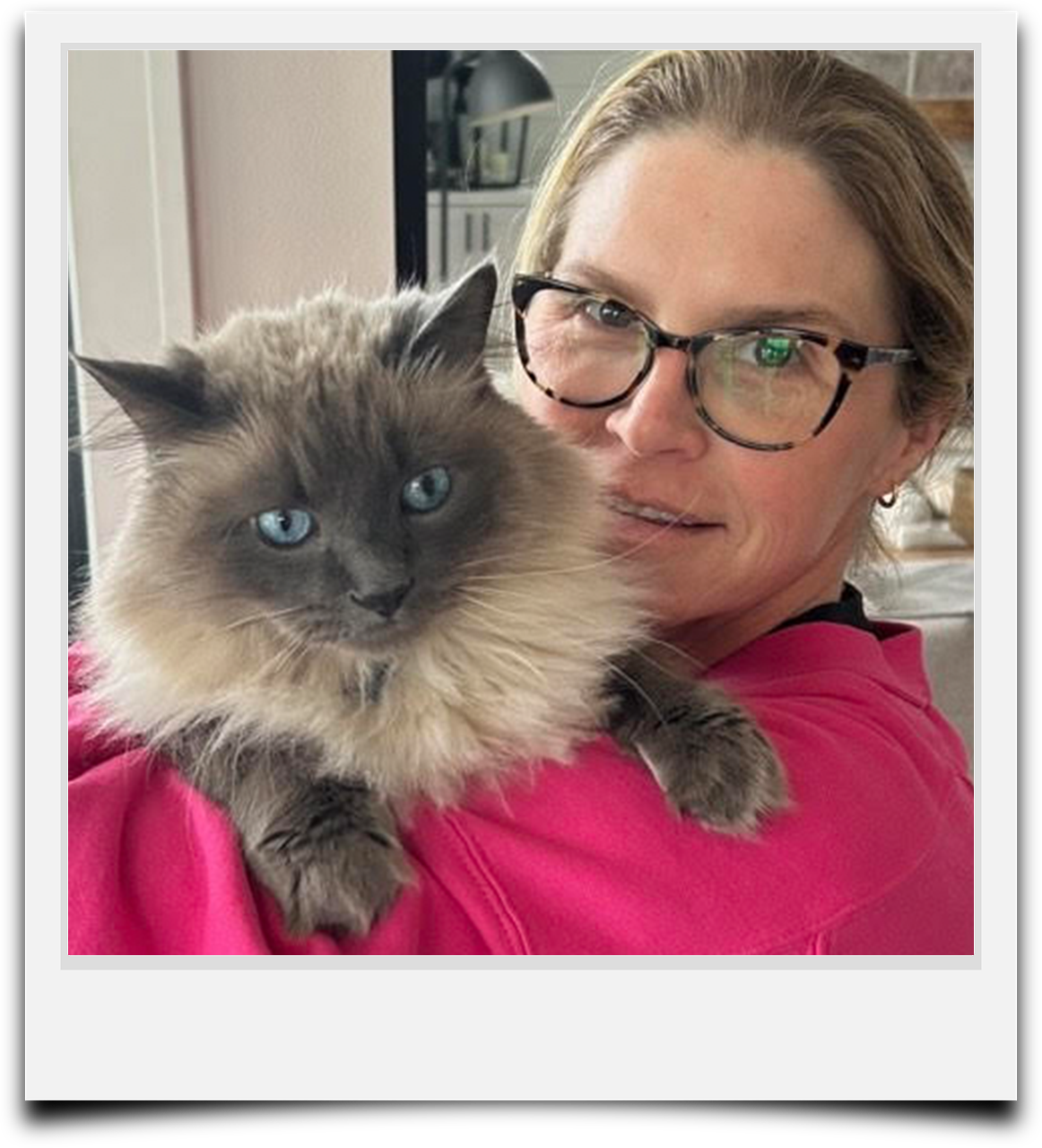 Heather is a caregiver with Auntie Abby's Professional Pet Sitting pictured with her cat.